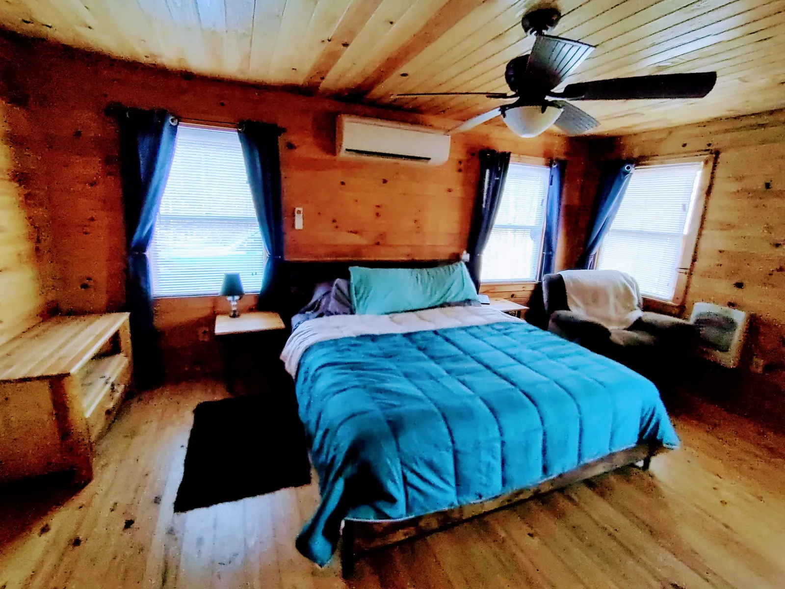 Luxury king bedroom featuring a private en suite bathroom and scenic forest views at our Turtletown TN cabin rental
