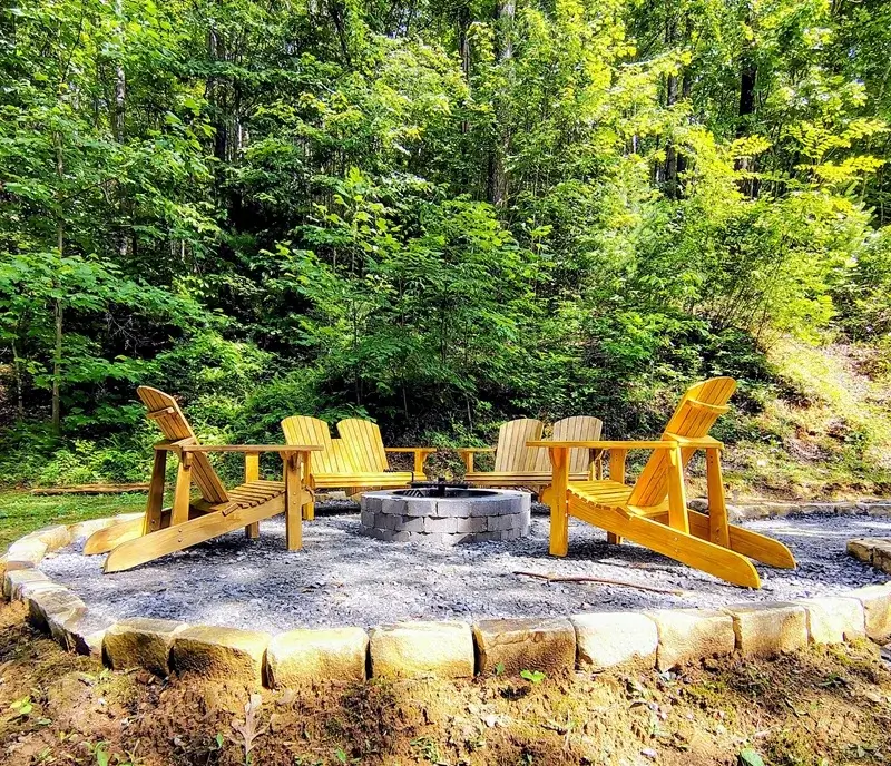 Relaxing outdoor firepit area surrounded by deep woods at our Turtletown TN vacation cabin getaway