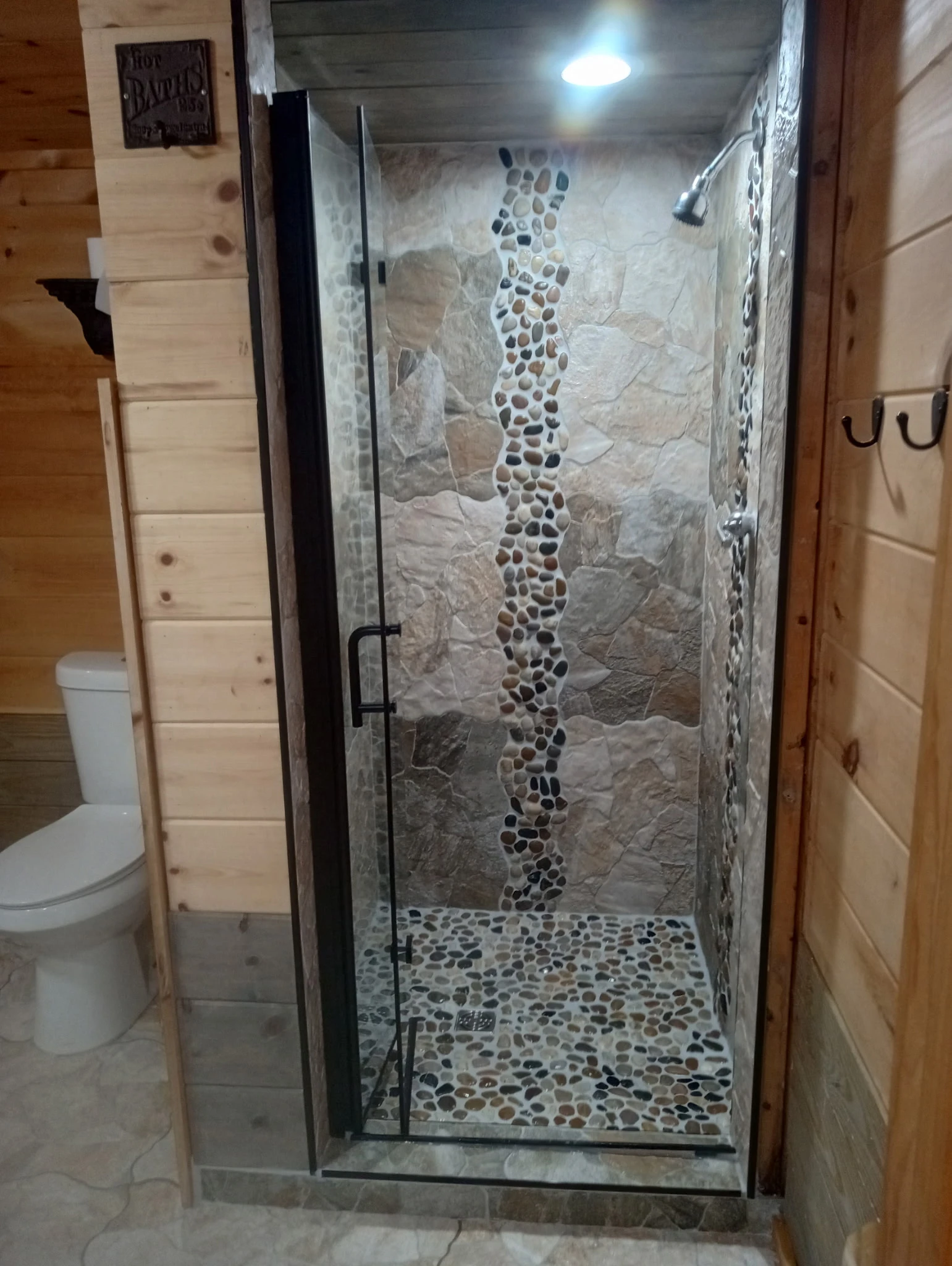 Guest bathroom and laundry with biophyllic pine and stone shower