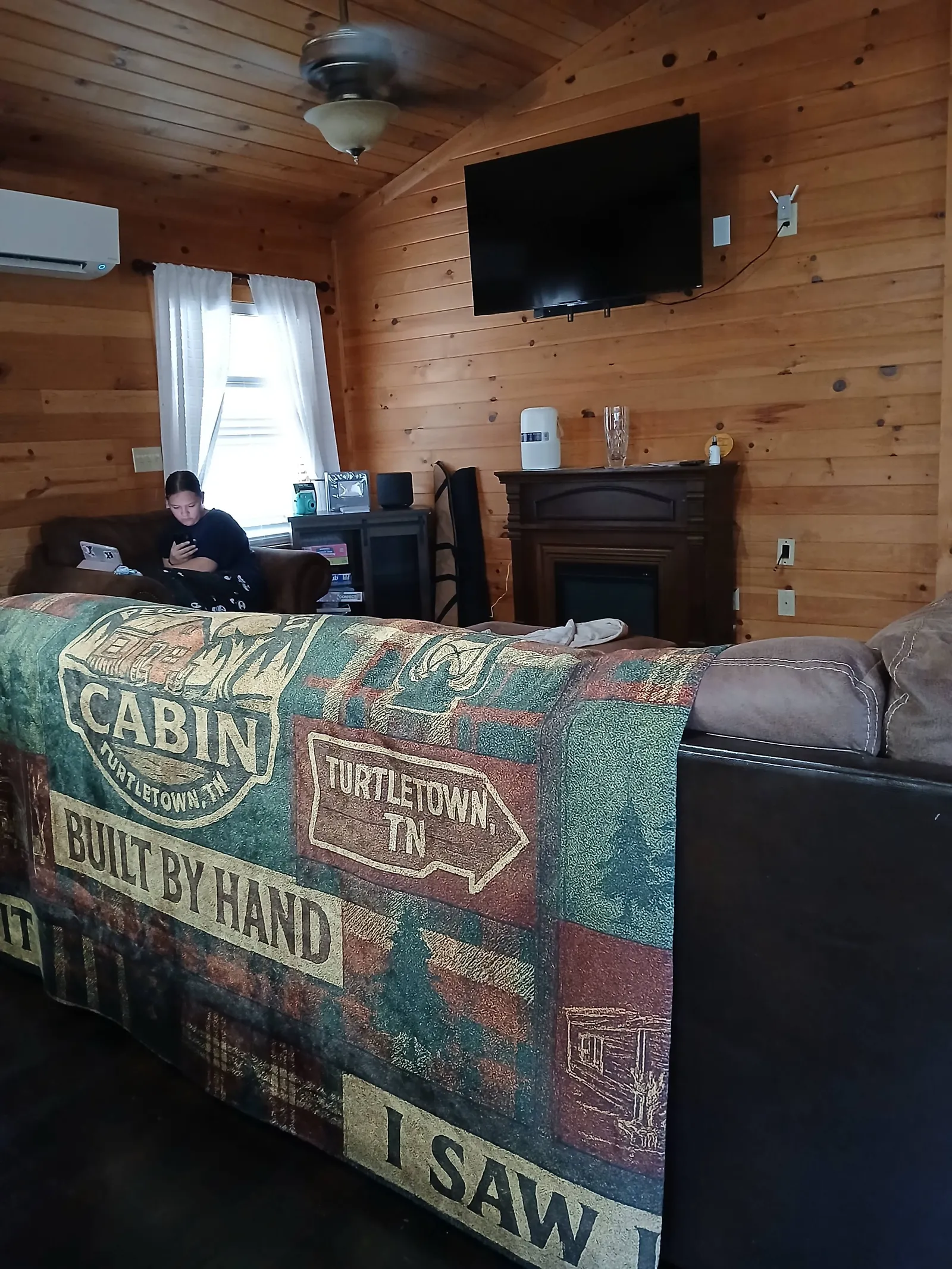 Cozy hand-built living room featuring authentic local woodwork at our mountain cabin vacation rental in Turtletown TN