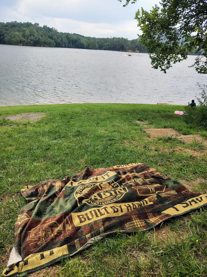 Lakeside picnic blanket spread out on Parksville Beach along Lake Ocoee near Turtletown TN