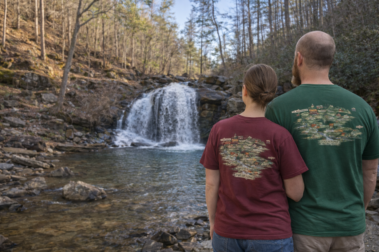 A couple wearing matching backroads map shirts while hiking Turtletown Creek Falls near our mountain cabin rental.